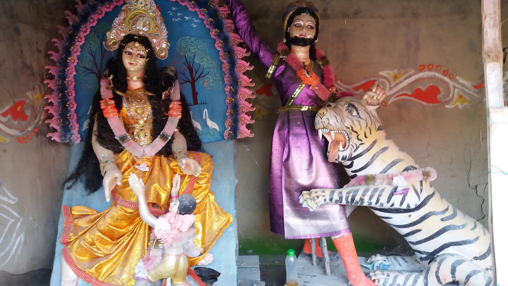Bonbibi with little Dukhe, Shah-Janguli, and Dakshin Ray, here appearing as a tiger.